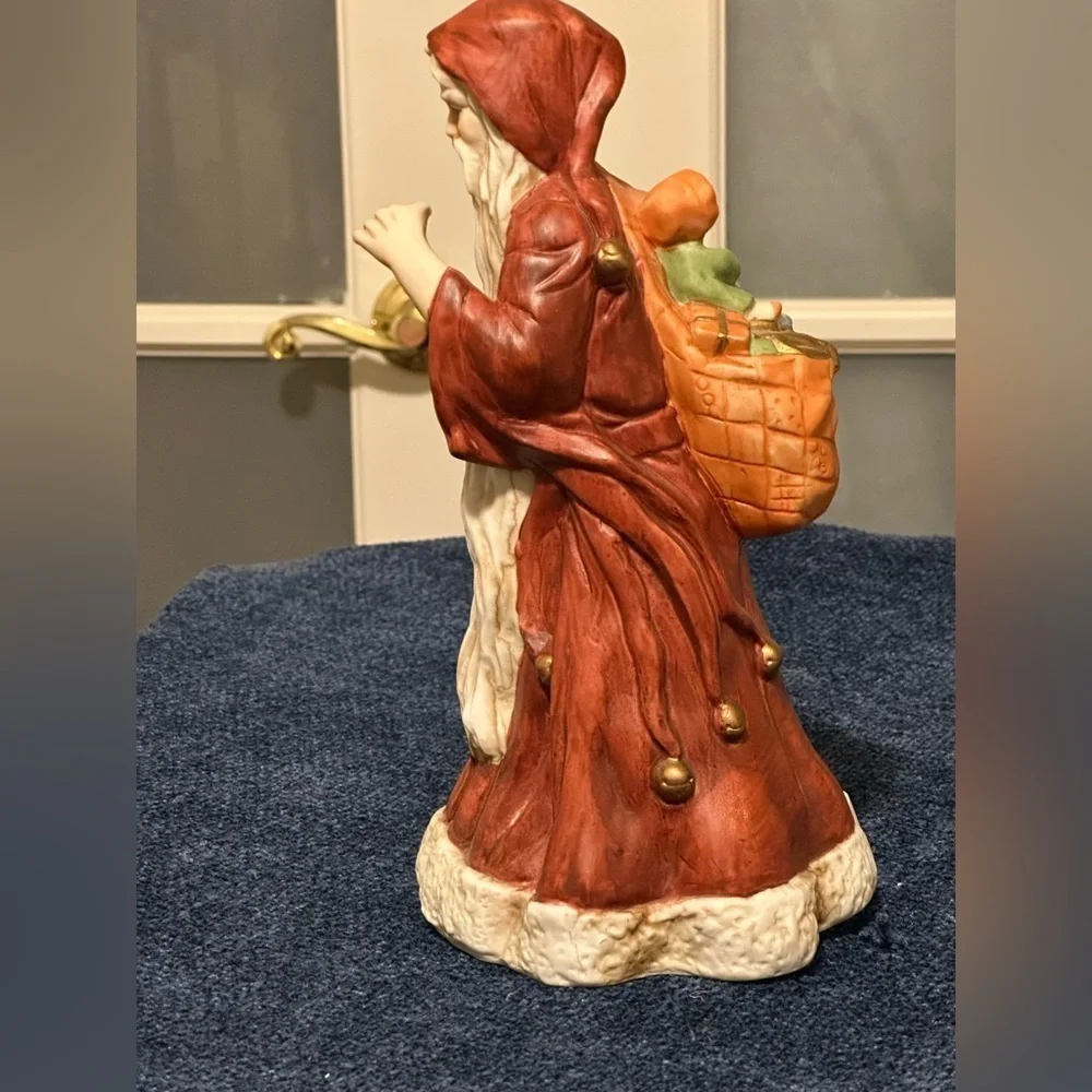 Incredible porcelain Santa carries his pack& wears a brownish robe.